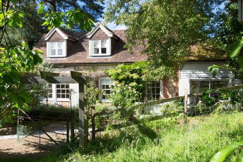 an old house with a fence in front of it at Coach House Kent in Seal