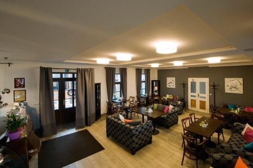 a living room with couches and tables and chairs at Ubytování Láskomina in Pacov