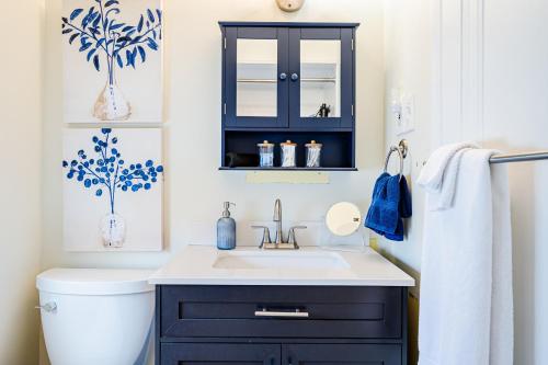 a bathroom with a sink and a blue cabinet at Rachel's Private Hideaway with king bed, kitchen, laundry, parking and big yard in Toledo