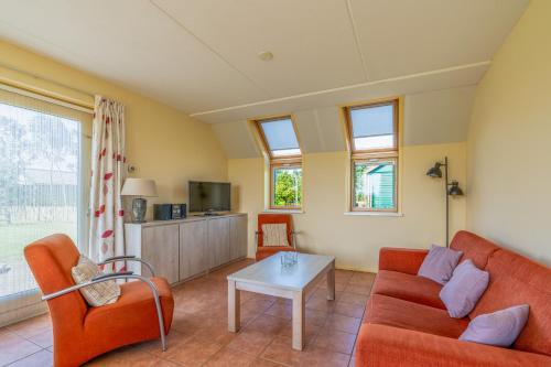 a living room with a couch and a table at Postweg 50 in De Cocksdorp