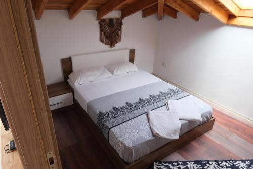 a bedroom with a bed in a room at Your charming sea view penthouse in Çeşme in Cesme