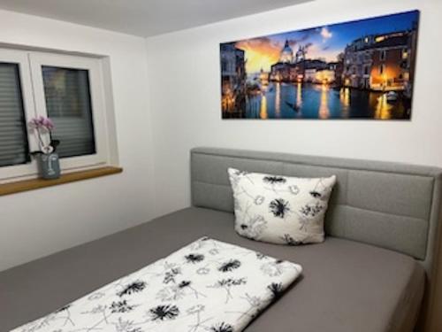 a couch with a pillow sitting next to a window at Ferienhaus bis 6 Personen in Weißensberg
