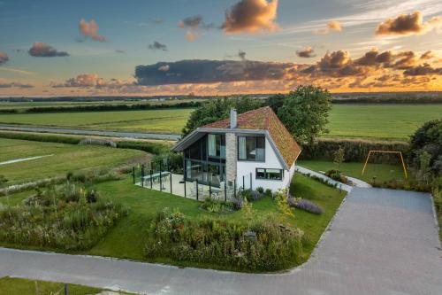 an overhead view of a small white house with a playground at Natuurvilla 14 Westerkolk in De Waal