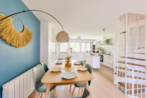 une salle à manger avec une table et des chaises en bois dans l'établissement Jolie maison - 150m plage du Fogeo et du port, à Arzon