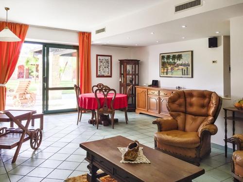 a living room filled with furniture and a table at Casa Vacanze Villa Flumini in Flumini di Quartu