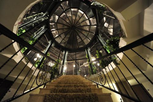 a spiral staircase in a building with a glass ceiling at Yucel Hotel in Usak