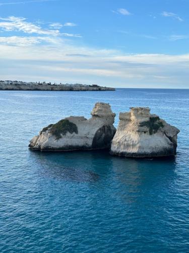 a large rock in the water in the ocean at La Tavernetta del Salento in Poggiardo