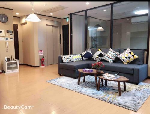 a living room with a couch and a table at 桜の舞3号馆 Sakura Dance 3 in Osaka
