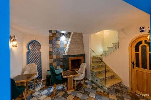a living room with a staircase and a fireplace at Dar Kisania in Chefchaouene
