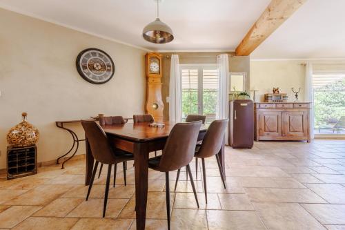 une cuisine et une salle à manger avec une table et des chaises en bois dans l'établissement La Maison de Mathis - Maison avec piscine privée, à Rousset-les-Vignes