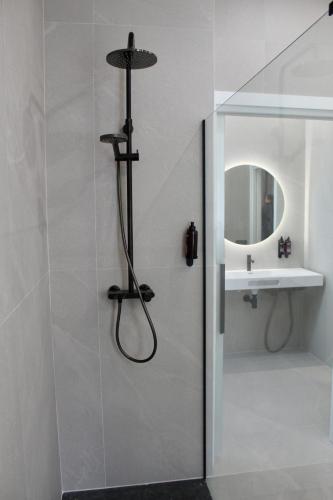 a shower in a bathroom with a sink at Mondragon Hotela in Arrasate - Mondragon