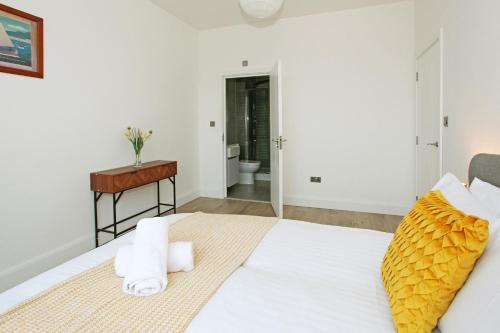 a bedroom with a bed with a desk and a bathroom at Sapphire House Apartments in Telford