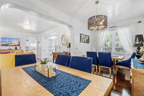 a dining room with a table and blue chairs at villa venezia bb in Miami Beach