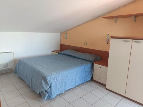 a bedroom with a bed and cabinets in it at Residence Marechiaro in Roseto degli Abruzzi