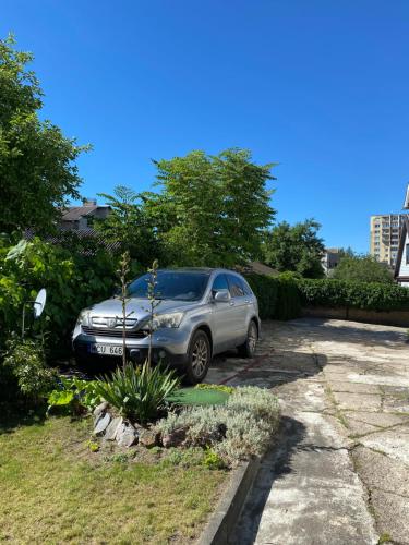 a silver car parked in a parking lot at „Sėlių Studio“ Apartamentai in Utena