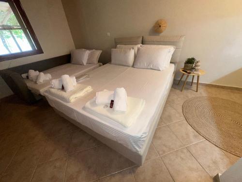 a bedroom with two beds with towels on them at AB Apartments in Samothráki