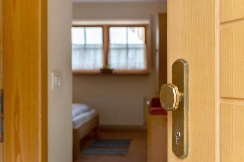 an open door to a room with a window at Friedheim Appartments in Sarntal