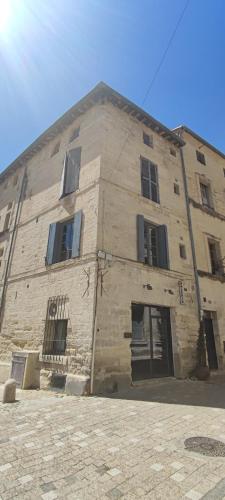 a large brick building with windows on the side of it at L'Echauguette d'Uzès by Les Demeures de Rachel in Uzès