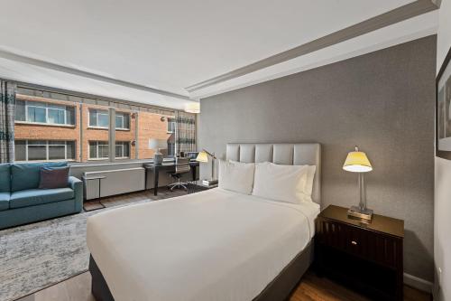 a bedroom with a bed and a couch and a desk at The River Inn in Washington