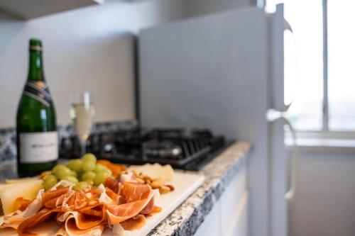 a counter with a bottle of wine and a plate of food at The River Inn in Washington