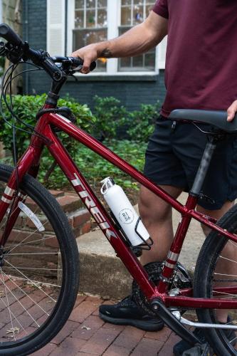 a man is standing next to a red bike at The River Inn in Washington