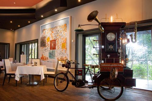 a bike parked in a dining room with a clock at Hennessy Park Hotel in Ebene