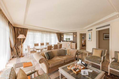 a living room with a couch and a table at Labourdonnais Waterfront Hotel in Port Louis