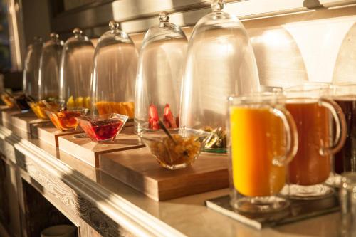 a row of glass bottles on a counter with drinks at Labourdonnais Waterfront Hotel in Port Louis