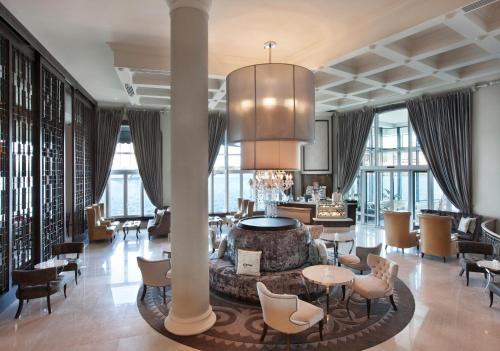 a lobby of a hotel with tables and chairs at Labourdonnais Waterfront Hotel in Port Louis