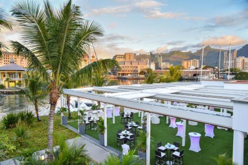 an aerial view of a resort with a palm tree at Le Suffren Hotel & Marina in Port Louis