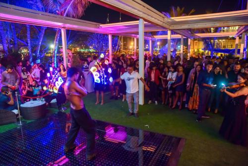 a group of people dancing at a party at Le Suffren Hotel & Marina in Port Louis