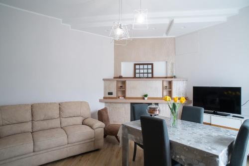 a living room with a couch and a table at Casa Gioia - Natura & Relax in Viggianello