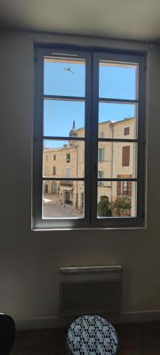 a window with a view of a building at L'Echauguette d'Uzès by Les Demeures de Rachel in Uzès