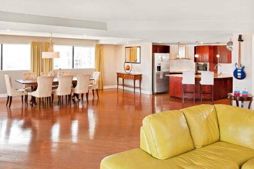a living room and kitchen with a couch and a table at Aloft Nashville West End in Nashville