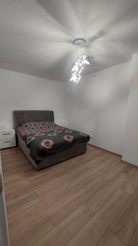 a bedroom with a bed on a wooden floor at Petreski Apartments 1 in Ohrid