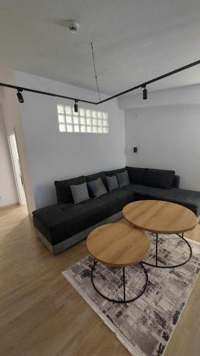 a living room with a couch and two tables at Petreski Apartments 1 in Ohrid