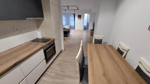 a kitchen with a long wooden table and a dining room at Petreski Apartments 1 in Ohrid