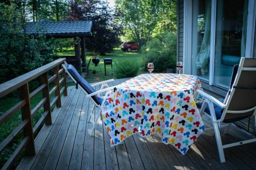 a table with an umbrella on a porch at Cozy beach cottage in Vääna-Jõesuu
