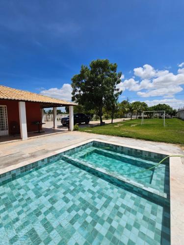 a swimming pool in front of a house at Chácara Urbana in Juazeiro