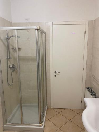 a shower with a glass door in a bathroom at Oasi Verde 1 in Lerici