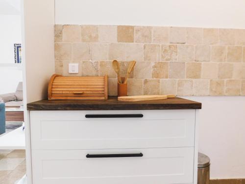 a white chest of drawers with a counter top at Casa Oliva Villa A with heating pool in Budva