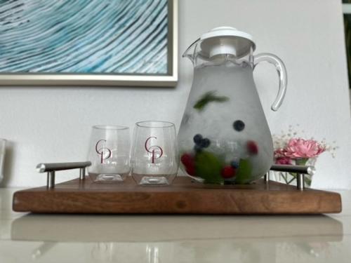 a tea kettle and two glasses on a wooden tray at Cannery Pier Hotel & Spa in Astoria, Oregon