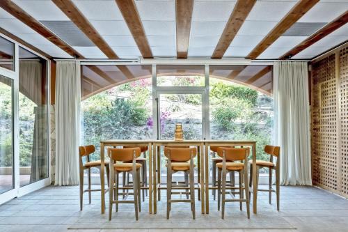 a dining room with a table and chairs at Veridia Resort Sardinia, a member of Radisson Individuals in Chia