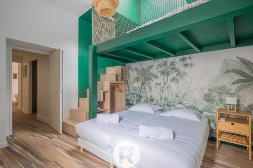 a bedroom with a large bed with a green canopy at Home 4 You in Grenoble