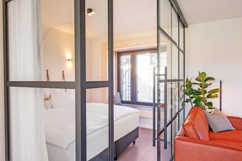 a bedroom with a bed and a glass door at Mono Design Apartments in Stuttgart