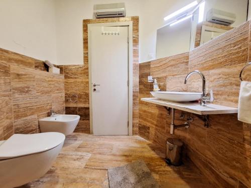 a bathroom with two sinks and a toilet at Casa Oliva Villa A with heating pool in Budva