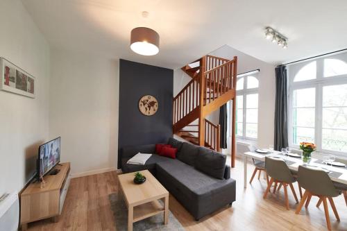 un salon avec un canapé et une table dans l'établissement L'Éclat Travot Central Lumineux Vue Sublime, à Cholet