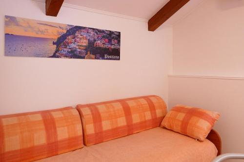 two orange cushions sitting on a couch in a room at Casa Vacanza Gialu in Erchie