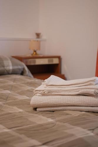 a stack of towels sitting on top of a bed at Casa Vacanza Gialu in Erchie
