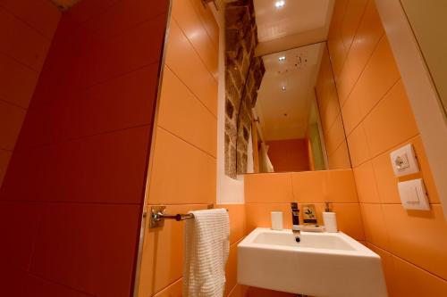 a bathroom with a sink and a mirror at Little Italy Hostel Ex Chiesa S Donato in Perugia
